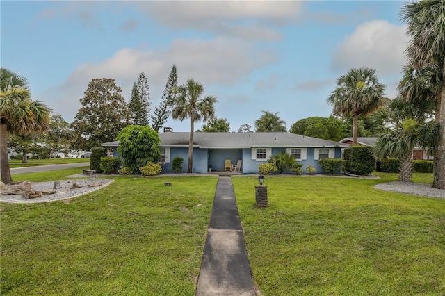 38 Fairway Cir, New Smyrna Beach, FL 32168 - ranch-style house with a front lawn