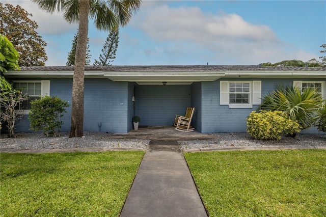 38 Fairway Cir, New Smyrna Beach, FL 32168 - view of front of house featuring a front yard and brick siding