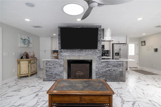 38 Fairway Cir, New Smyrna Beach, FL 32168 - living area with light marble finish flooring, ceiling fan, a fireplace, and recessed lighting