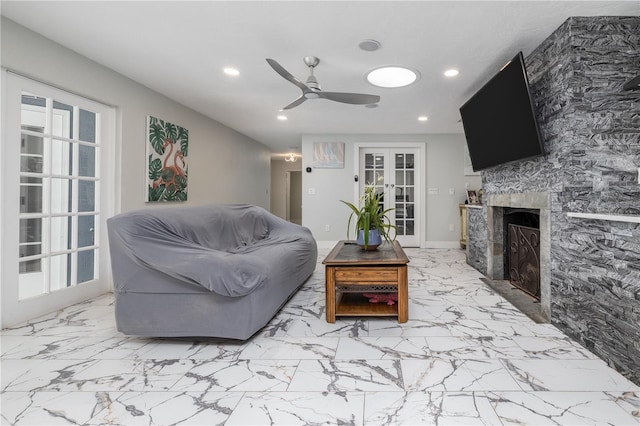 38 Fairway Cir, New Smyrna Beach, FL 32168 - living room featuring recessed lighting, ceiling fan, a fireplace, marble finish floors, and french doors