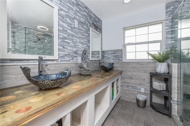 38 Fairway Cir, New Smyrna Beach, FL 32168 - bathroom with tile walls, a stall shower, tile patterned floors, and vanity