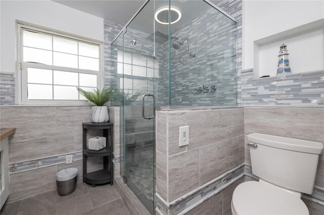 38 Fairway Cir, New Smyrna Beach, FL 32168 - bathroom with tile walls, a stall shower, tile patterned flooring, and vanity