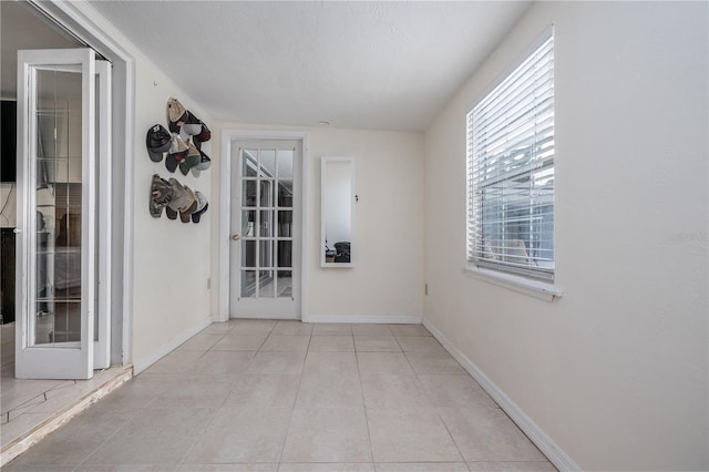 38 Fairway Cir, New Smyrna Beach, FL 32168 - hallway with baseboards and light tile patterned flooring