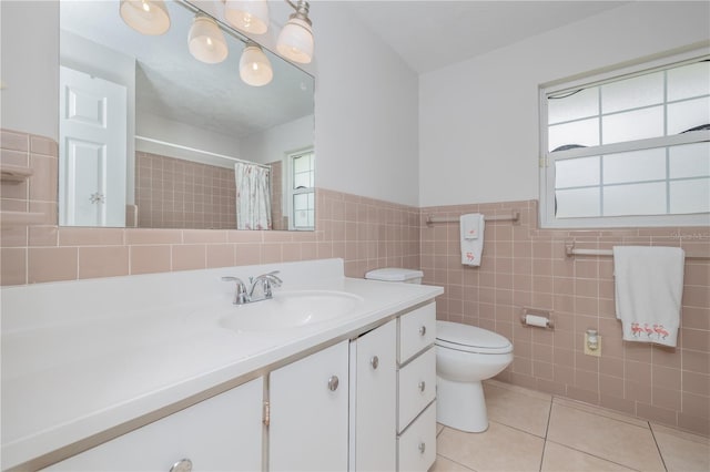 38 Fairway Cir, New Smyrna Beach, FL 32168 - bathroom with vanity, tile patterned flooring, plenty of natural light, tile walls, and a shower with shower curtain