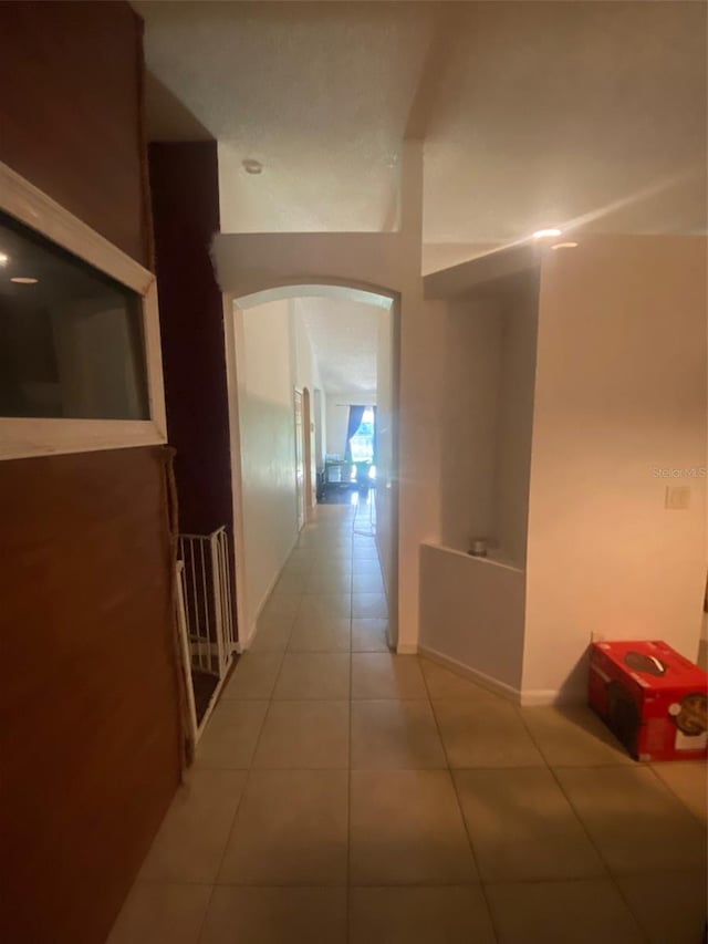 2122 Orange Tree Dr, Edgewater, FL 32141 - corridor with arched walkways and tile patterned floors