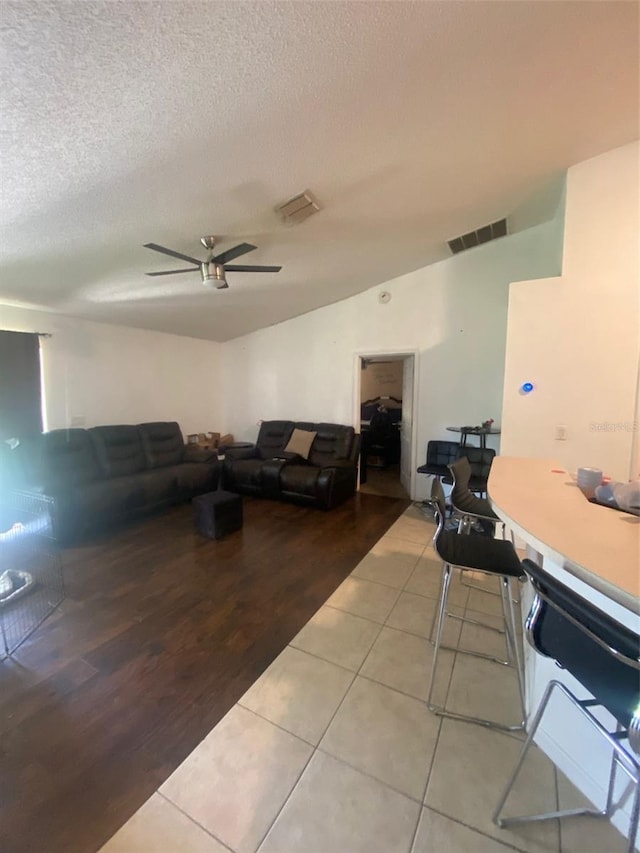 2122 Orange Tree Dr, Edgewater, FL 32141 - living room featuring a ceiling fan, a textured ceiling, and light tile patterned floors
