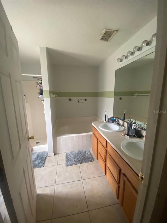 2122 Orange Tree Dr, Edgewater, FL 32141 - full bath with double vanity, a bath, tile patterned flooring, and a shower stall