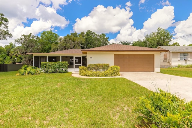 5060 Audubon Ave, De Leon Springs, FL 32130 - ranch-style house with a garage, concrete driveway, a front yard, and a sunroom