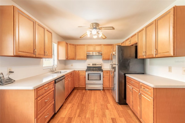 5060 Audubon Ave, De Leon Springs, FL 32130 - kitchen featuring stainless steel appliances, under cabinet range hood, ceiling fan, light wood-style floors, and light countertops
