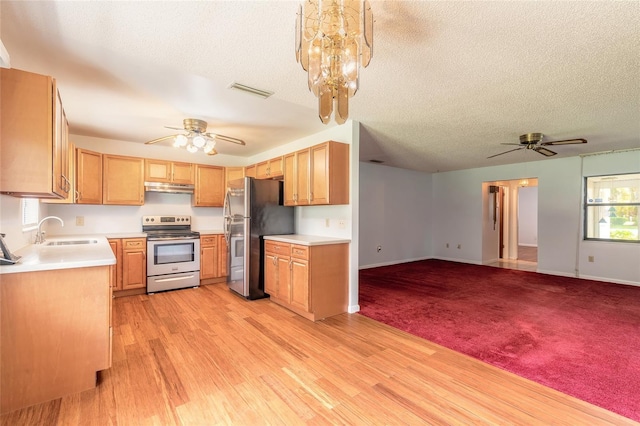 5060 Audubon Ave, De Leon Springs, FL 32130 - kitchen with appliances with stainless steel finishes, a ceiling fan, open floor plan, light countertops, and a textured ceiling