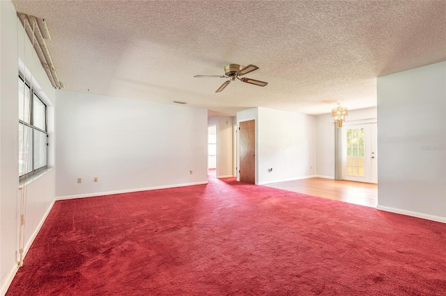5060 Audubon Ave, De Leon Springs, FL 32130 - empty room featuring carpet flooring, a ceiling fan, a chandelier, and a textured ceiling