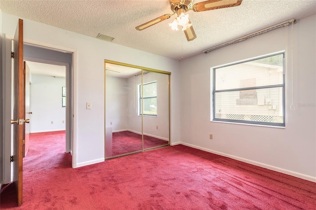 5060 Audubon Ave, De Leon Springs, FL 32130 - unfurnished bedroom with carpet floors, a textured ceiling, a closet, and ceiling fan