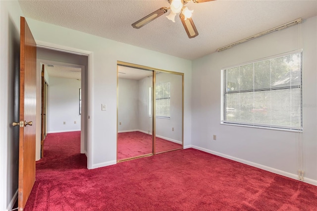 5060 Audubon Ave, De Leon Springs, FL 32130 - unfurnished bedroom featuring carpet flooring, a closet, a textured ceiling, and ceiling fan