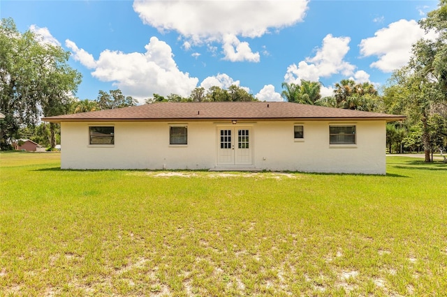 5060 Audubon Ave, De Leon Springs, FL 32130 - rear view of house with french doors, a lawn, and stucco siding