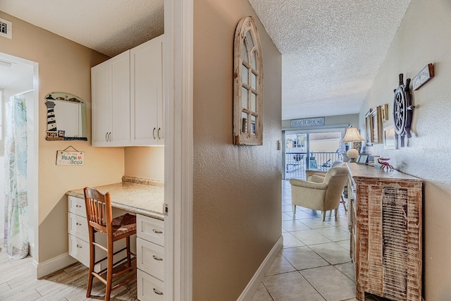 3700 S Atlantic Ave Unit 108, New Smyrna Beach, FL 32169 - hall with a textured ceiling and a desk