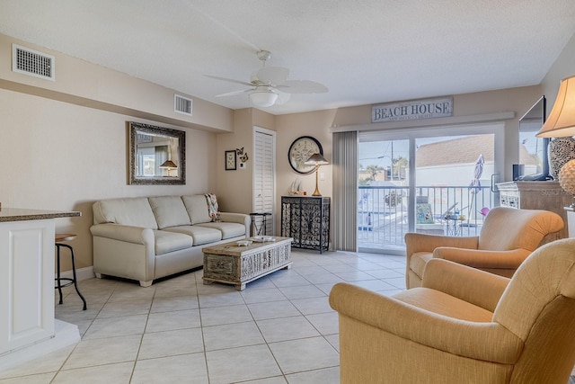 3700 S Atlantic Ave Unit 108, New Smyrna Beach, FL 32169 - living room with a ceiling fan and light tile patterned floors