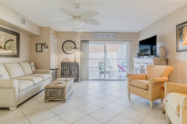 3700 S Atlantic Ave Unit 108, New Smyrna Beach, FL 32169 - living room with a ceiling fan, light tile patterned floors, and a textured ceiling