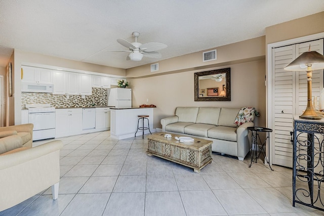 3700 S Atlantic Ave Unit 108, New Smyrna Beach, FL 32169 - living room with a ceiling fan and light tile patterned flooring