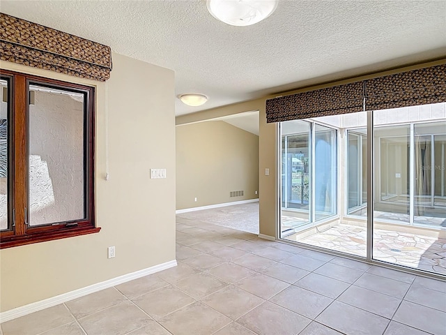 26 Creek Ct, Palm Coast, FL 32137 - spare room featuring light tile patterned flooring and a textured ceiling