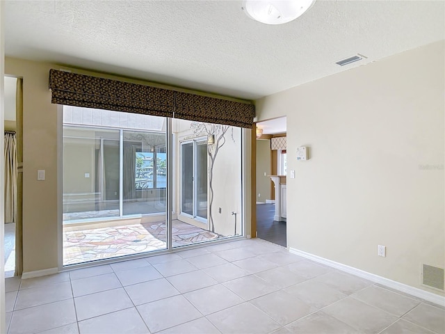 26 Creek Ct, Palm Coast, FL 32137 - unfurnished room with a textured ceiling and light tile patterned floors