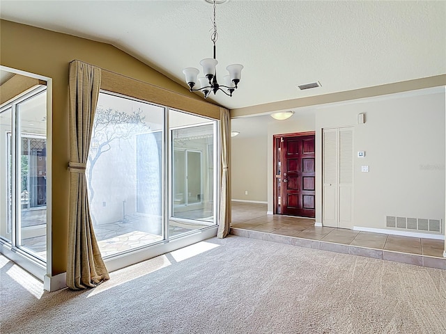 26 Creek Ct, Palm Coast, FL 32137 - carpeted empty room with a chandelier, lofted ceiling, a textured ceiling, and tile patterned floors