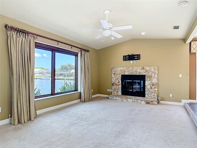 26 Creek Ct, Palm Coast, FL 32137 - unfurnished living room with ceiling fan, carpet, vaulted ceiling, and a stone fireplace