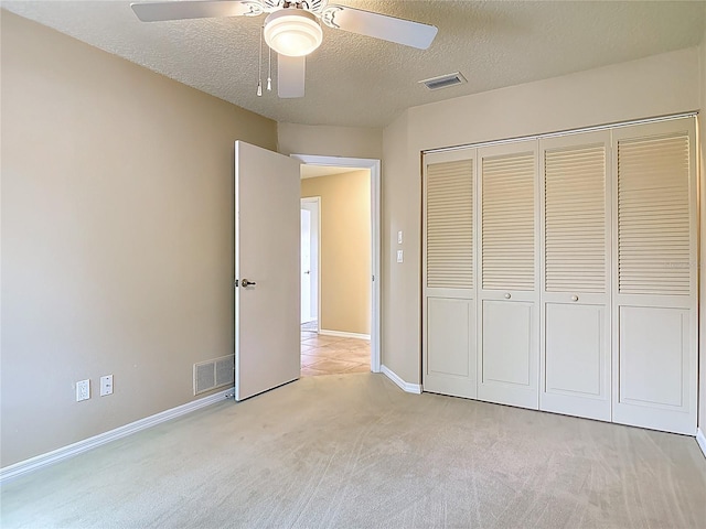 26 Creek Ct, Palm Coast, FL 32137 - unfurnished bedroom featuring light carpet, a textured ceiling, a closet, and a ceiling fan