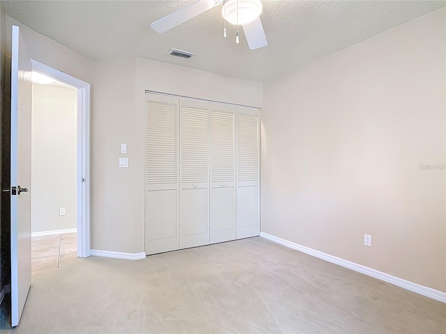 26 Creek Ct, Palm Coast, FL 32137 - unfurnished bedroom featuring a closet, light colored carpet, and ceiling fan