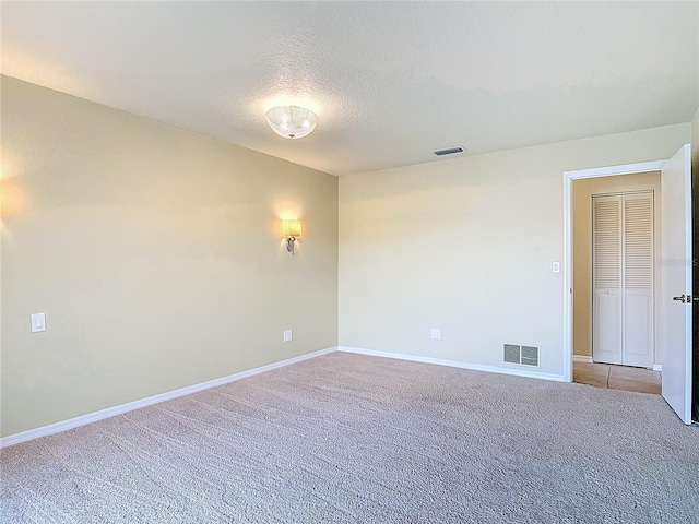 26 Creek Ct, Palm Coast, FL 32137 - empty room with carpet and a textured ceiling