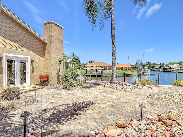 26 Creek Ct, Palm Coast, FL 32137 - view of patio with a water view, french doors, and a boat dock