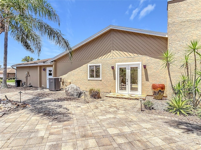 26 Creek Ct, Palm Coast, FL 32137 - rear view of property with stucco siding and french doors