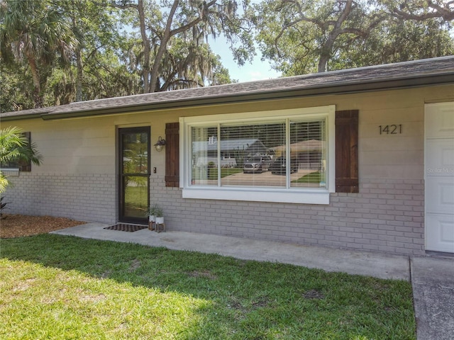 1421 Pine Tree Dr, Edgewater, FL 32132 - view of front of home with brick siding and a front yard