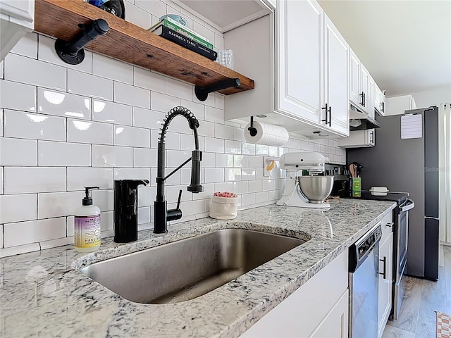 1421 Pine Tree Dr, Edgewater, FL 32132 - kitchen with stainless steel appliances, open shelves, backsplash, light stone counters, and white cabinets
