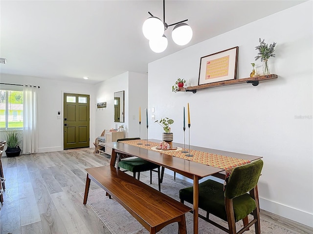1421 Pine Tree Dr, Edgewater, FL 32132 - dining room featuring light wood-type flooring and a chandelier