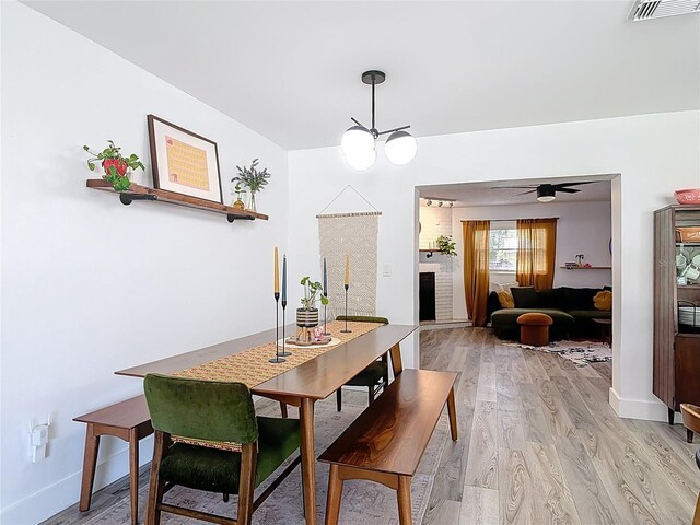 1421 Pine Tree Dr, Edgewater, FL 32132 - dining space with light wood-style flooring and a chandelier