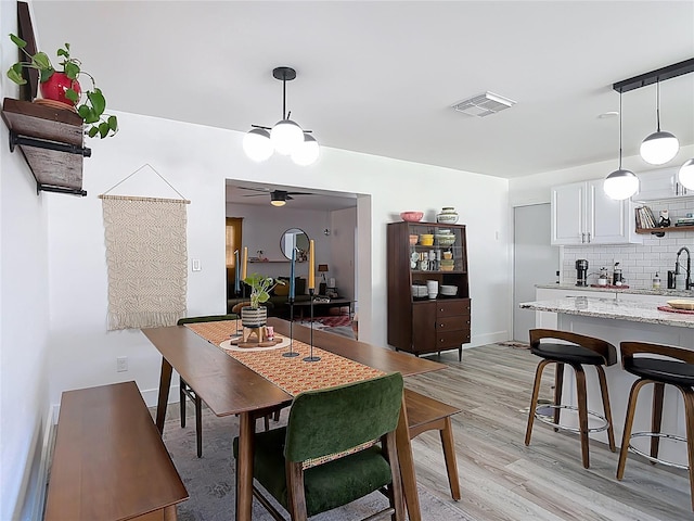 1421 Pine Tree Dr, Edgewater, FL 32132 - dining space featuring light wood-type flooring and a ceiling fan