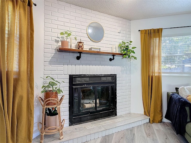 1421 Pine Tree Dr, Edgewater, FL 32132 - detailed view of wood finished floors, a textured ceiling, and a fireplace