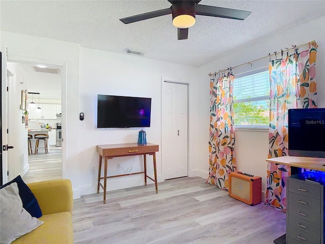 1421 Pine Tree Dr, Edgewater, FL 32132 - recreation room with wood finished floors, a textured ceiling, and a ceiling fan