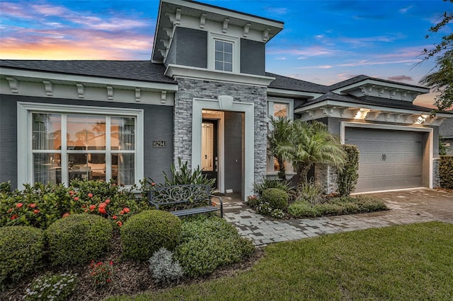 6294 W Fallsgrove Ln, Port Orange, FL 32128 - italianate house featuring driveway, stucco siding, roof with shingles, and stone siding