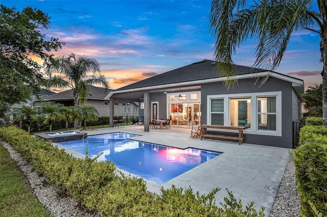 6294 W Fallsgrove Ln, Port Orange, FL 32128 - back of house featuring a patio area, stucco siding, ceiling fan, and a pool with connected hot tub
