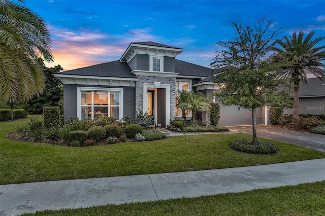 6294 W Fallsgrove Ln, Port Orange, FL 32128 - view of front of house featuring stone siding, stucco siding, driveway, a yard, and a shingled roof