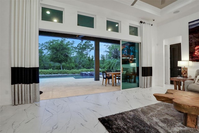 6294 W Fallsgrove Ln, Port Orange, FL 32128 - doorway to outside featuring a high ceiling, marble finish floors, and plenty of natural light