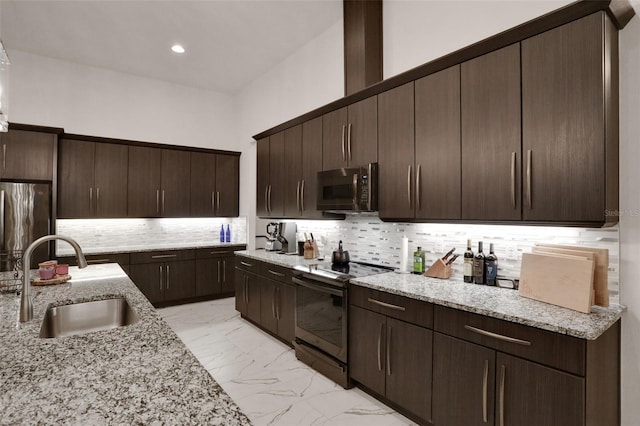 6294 W Fallsgrove Ln, Port Orange, FL 32128 - kitchen featuring electric stove, freestanding refrigerator, dark brown cabinets, light marble finish flooring, and tasteful backsplash
