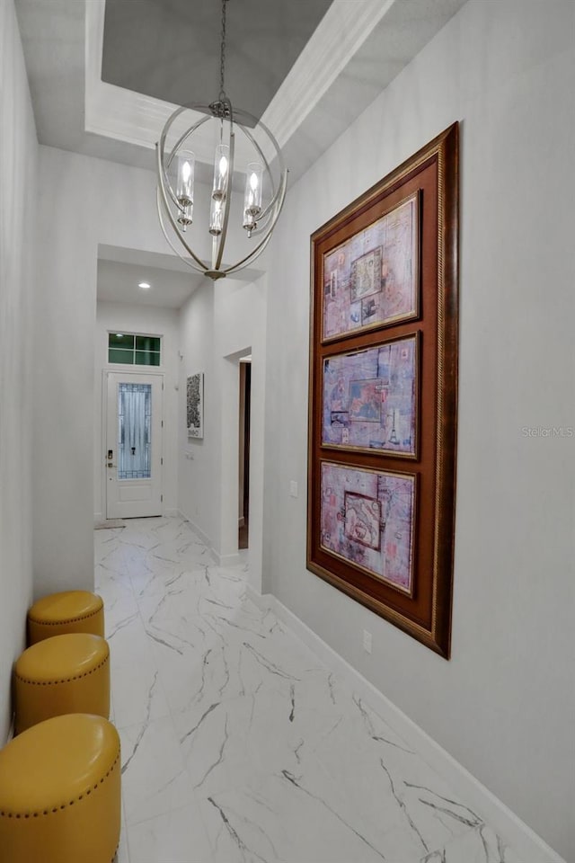 6294 W Fallsgrove Ln, Port Orange, FL 32128 - hall featuring a chandelier, marble finish floors, and a tray ceiling