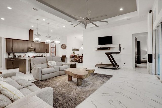 6294 W Fallsgrove Ln, Port Orange, FL 32128 - living room featuring recessed lighting, light marble finish floors, a ceiling fan, a chandelier, and a high ceiling
