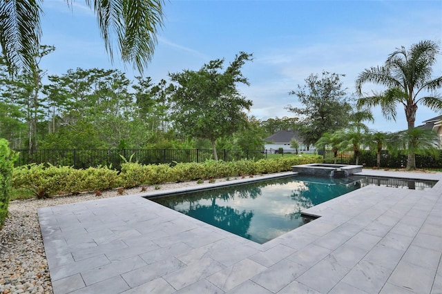 6294 W Fallsgrove Ln, Port Orange, FL 32128 - view of pool featuring a patio, a pool with connected hot tub, and a fenced backyard