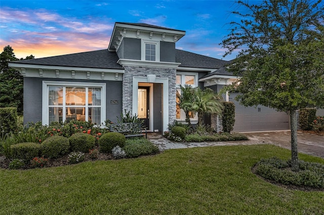 6294 W Fallsgrove Ln, Port Orange, FL 32128 - view of front of property featuring a yard, stone siding, a shingled roof, driveway, and a garage