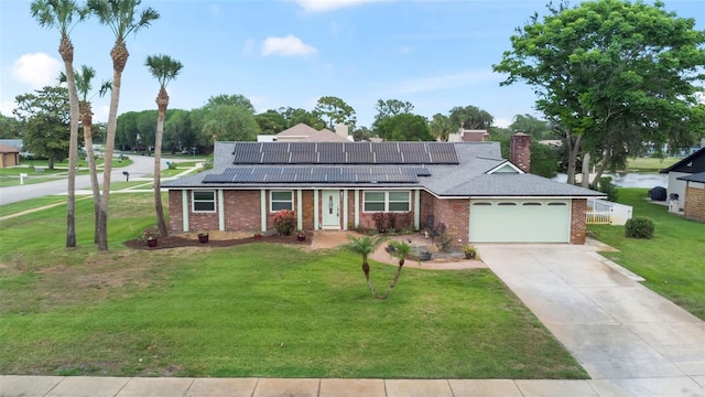 800 Black Duck Dr, Port Orange, FL 32127 - ranch-style home with brick siding, an attached garage, a front yard, roof mounted solar panels, and driveway