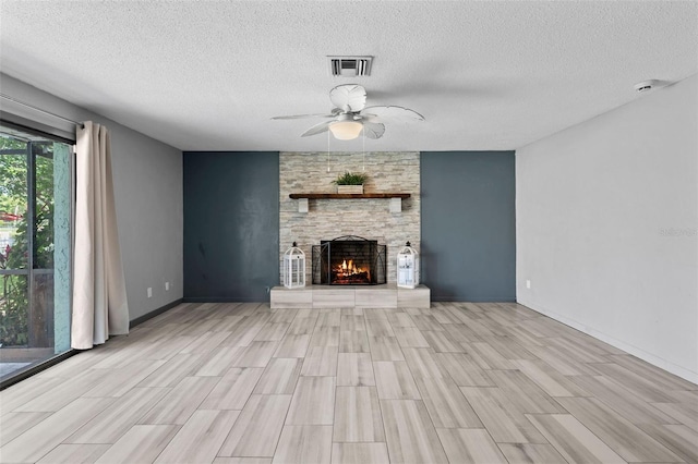800 Black Duck Dr, Port Orange, FL 32127 - unfurnished living room featuring a textured ceiling, ceiling fan, light wood-type flooring, and a fireplace