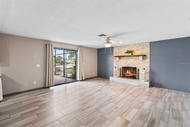 800 Black Duck Dr, Port Orange, FL 32127 - unfurnished living room featuring a ceiling fan, a textured ceiling, a fireplace, and wood finish floors